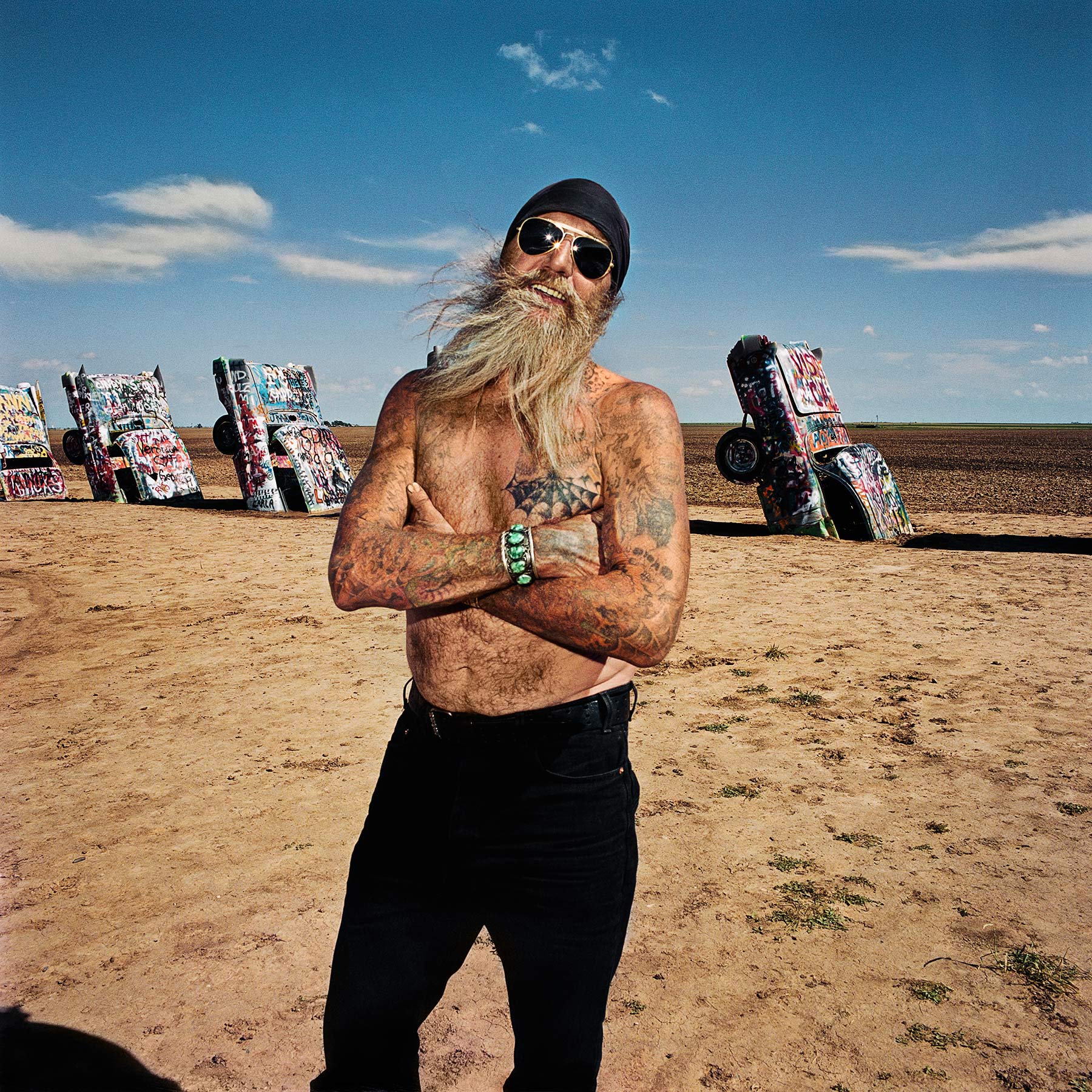 Man with Tattoos at Cadillac Ranch, TX 1998 - Sightseer Series - Photo by Roger Minick