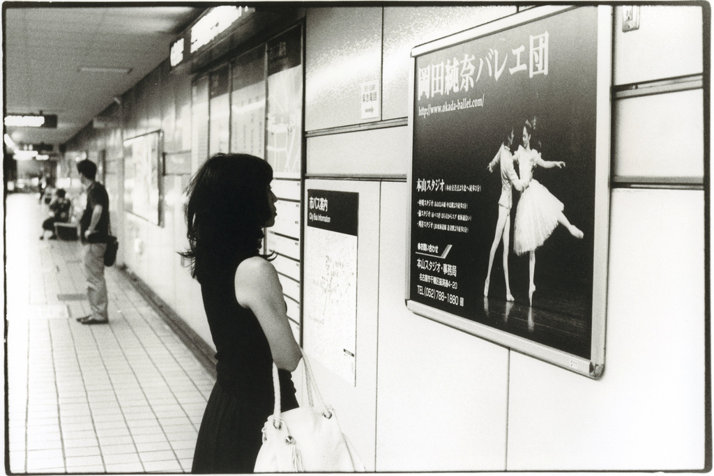 Untitled - Girl Looking at Ad - Photo by Junku Nishimura